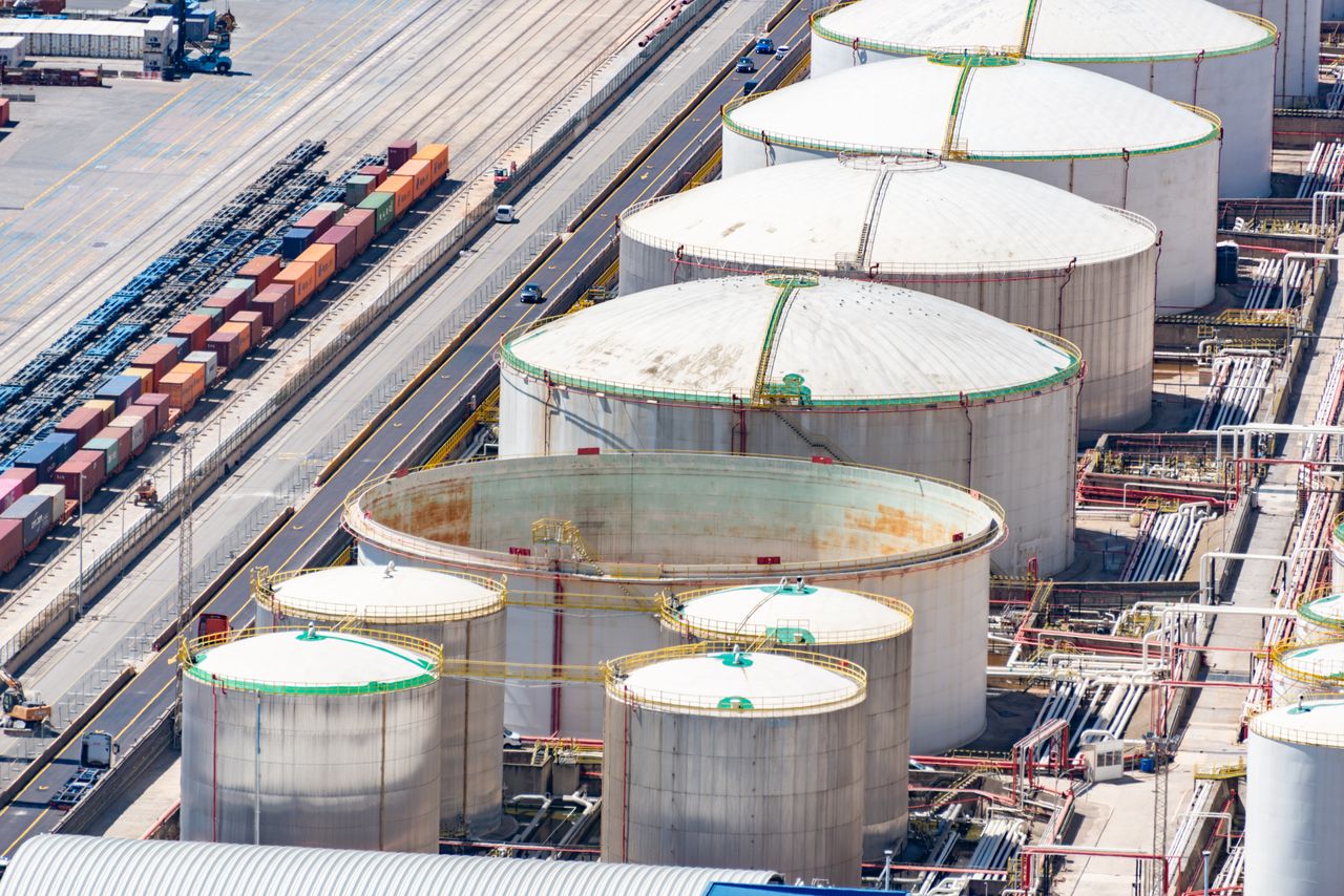 Crafting Captivating Headlines: Your awesome post title goes here Aerial shot of large oil storage tanks in an industrial district with adjacent railway tracks.