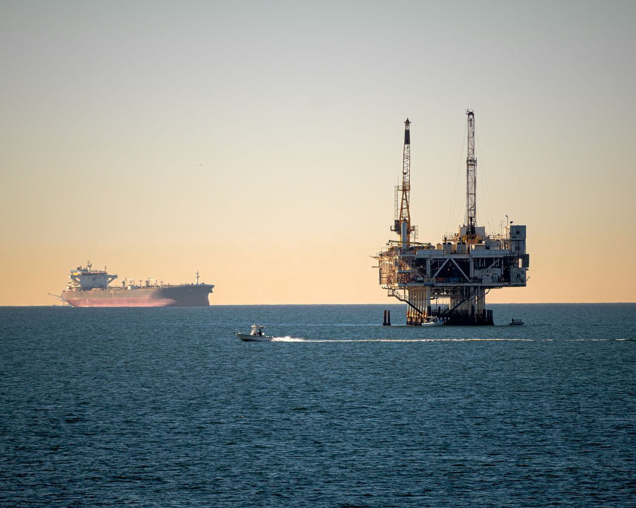 The Art of Drawing Readers In: Your attractive post title goes here Offshore oil platform with container ship in tranquil sea during daytime.